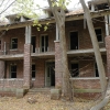 <p><strong>Craftsman-influenced Colonial Revival, details</strong>: Porch with tall brick piers and square wood columns. Officers&#39; Quarters (Building 12), view west, November 2005.</p>